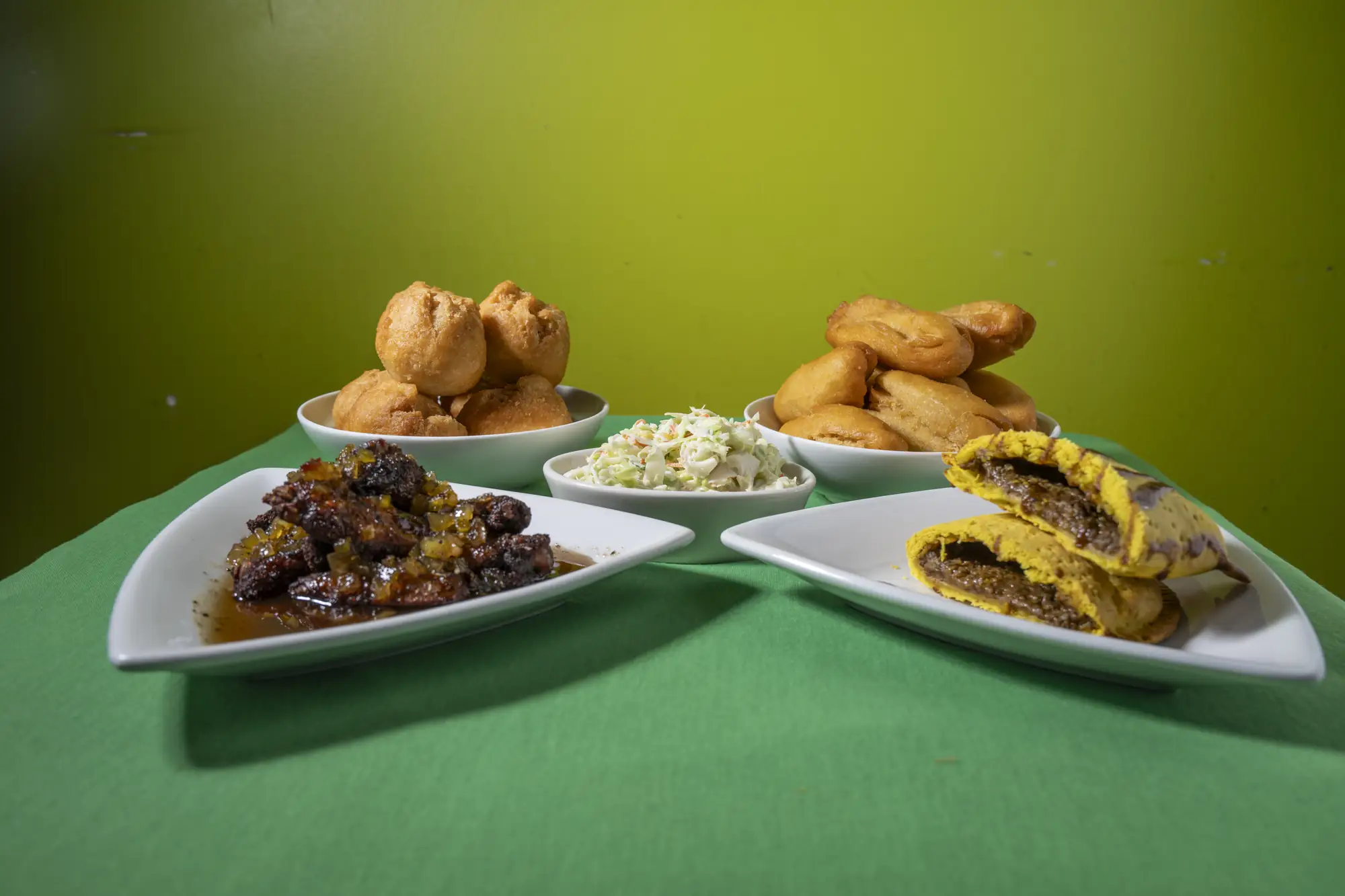 Jerk chicken, beef patties and festival served family style