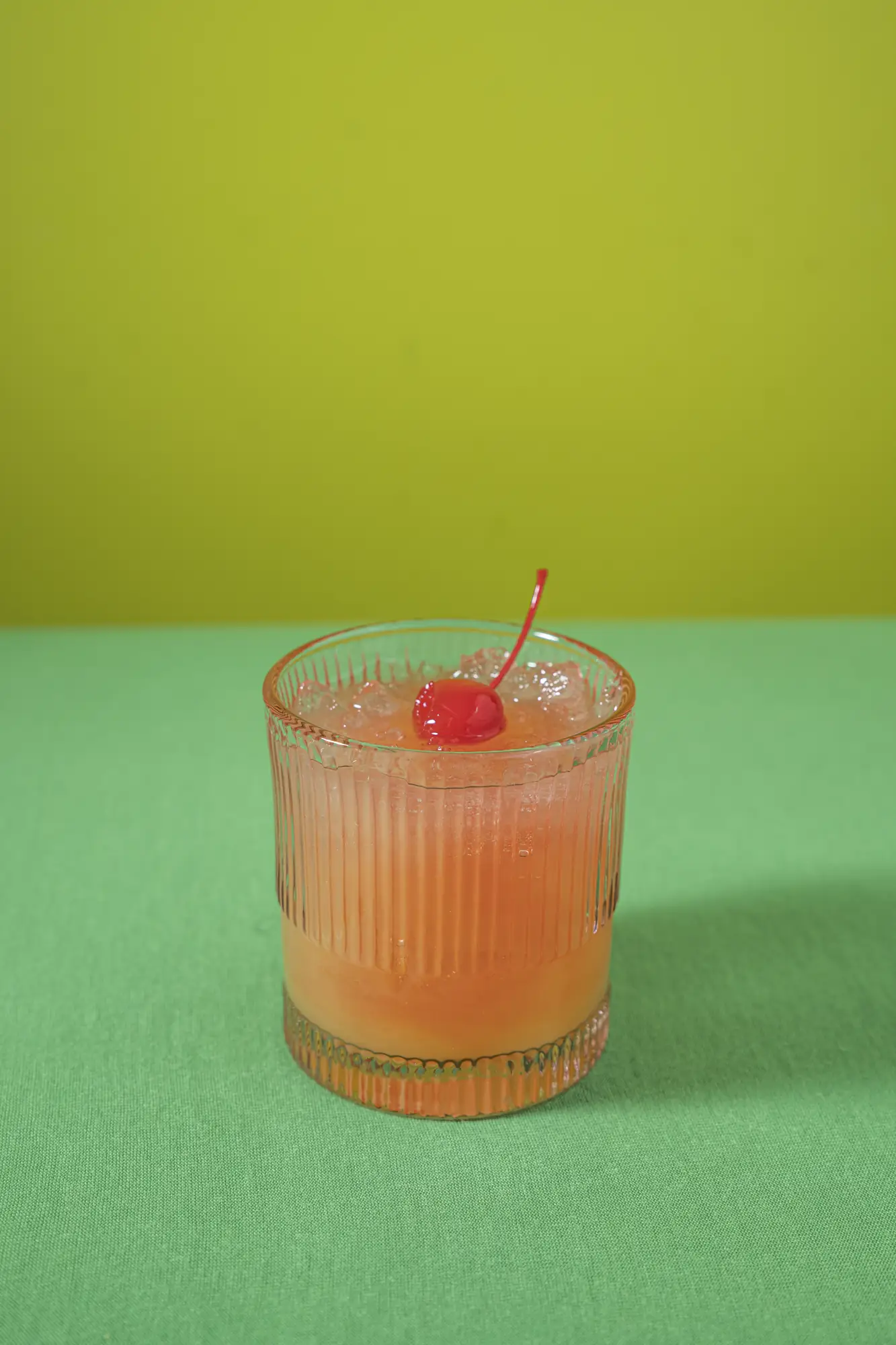 Rum punch cocktail with a cherry