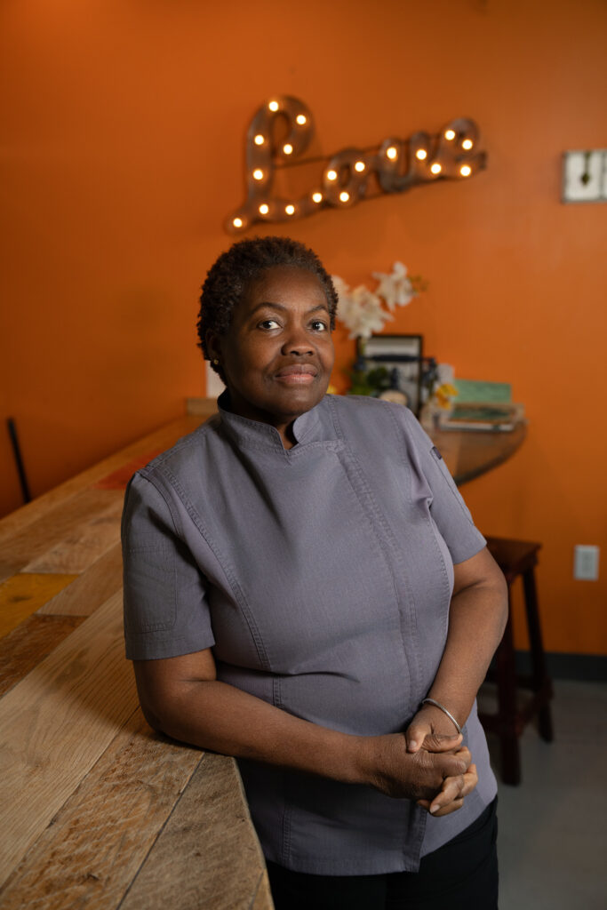 Chef Sheron Grant standing at the bar inside 11Hauz