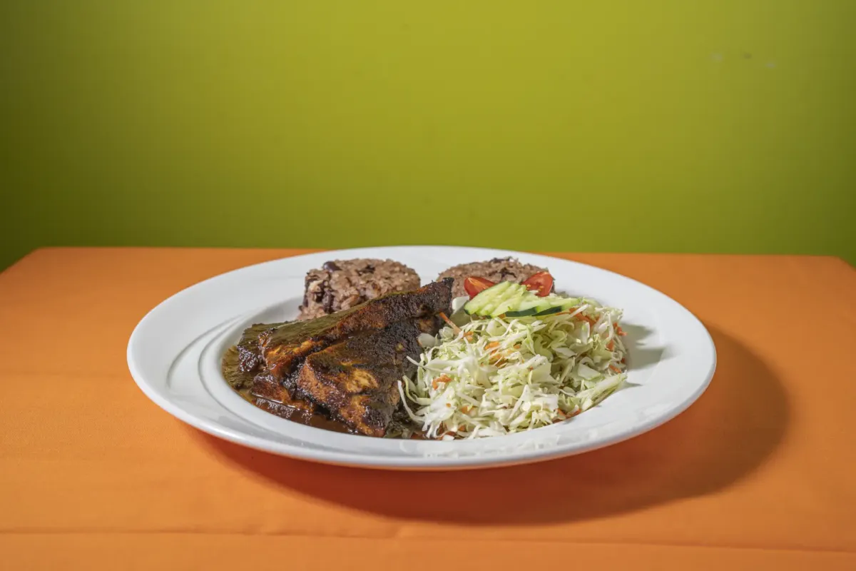 Vegan jerk tofu with rice and peas and cabbage salad